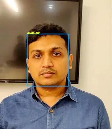 A man facing the camera, his face inside a detection box labelled with his name.